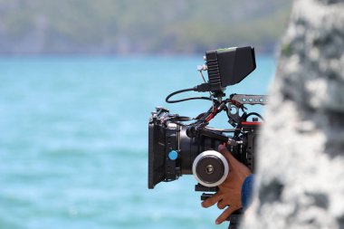 Kameraman okyanus manzarasının fotoğraflarını ve videosunu çekiyor