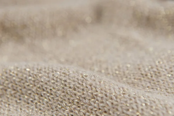 Крупный план трикотажного бежевого и золотого цвета текстиля — стоковое фото