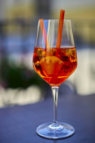 Cocktail aperol spritz on the multicolored background