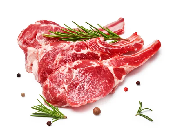 Three pieces of mutton meat with herbs and mixed peppers isolated on white background. Mutton steaks with rosemary.