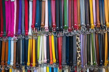 Firenze, İtalya - 23 Haziran 2019: Piyasada satılan çok renkli deri kemerlerin arka planı.