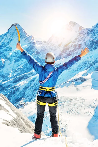 Wspinacz osiąga szczyt szczytu góry. Wspinaczka i sporty wspinaczkowe. Góry Nepalskie. — Zdjęcie stockowe