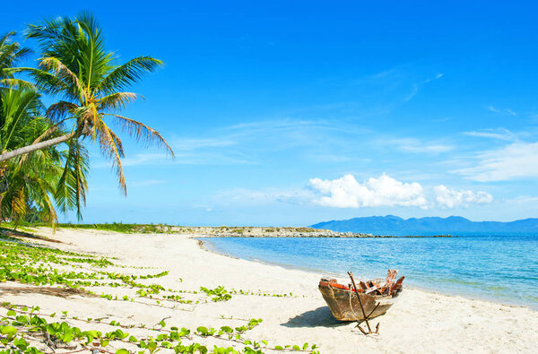 Old fisherman boat with anchor on the tropical palm beach. Tropical beach. Beautiful tropical island.