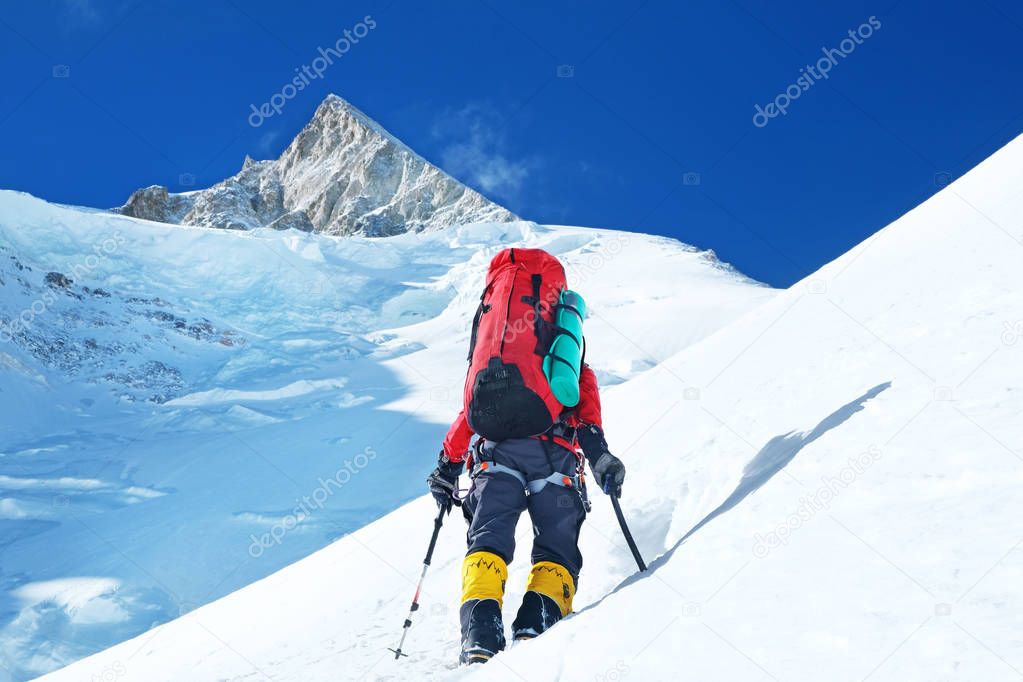 Climber reaches the summit of mountain peak. Success, freedom and happiness, achievement in mountains. Climbing sport concept.