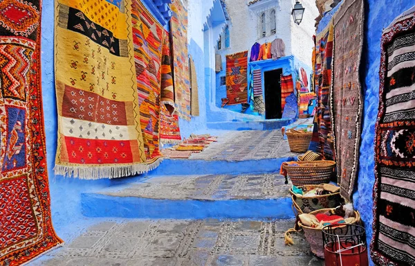 Typical beautiful moroccan architecture in Chefchaouen blue city medina in Morocco with blue walls, details, colorful flower pots and household items