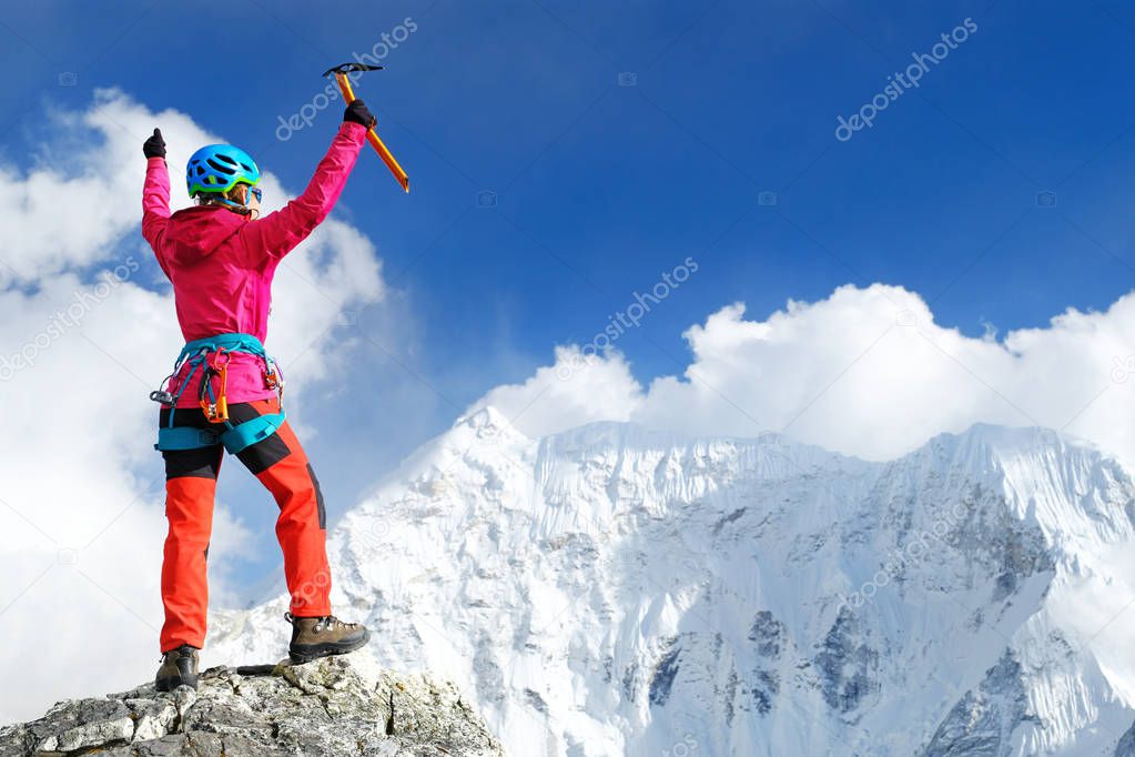Climber reaches the summit of mountain peak enjoying the next victory of the ascent. Success, freedom and happiness, achievement in mountains. Climbing sport concept.