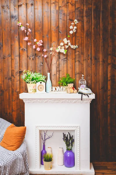 cozy home interior, clock, vase with flowers, toy bear, sofa