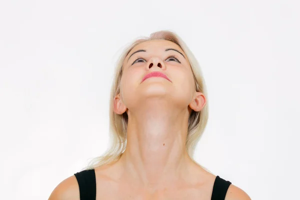 Face exercise  giraffe, woman looks up to the ceiling