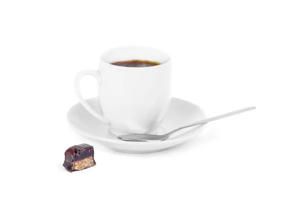 Kopje koffie met een stuk van snoep — Stockfoto