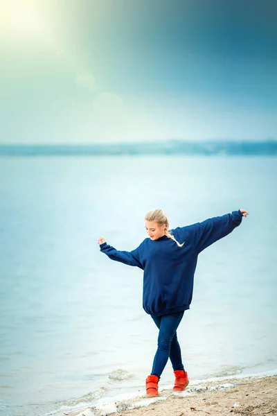 Young woman dancing on the river Bank in spring or autumn — 스톡 사진