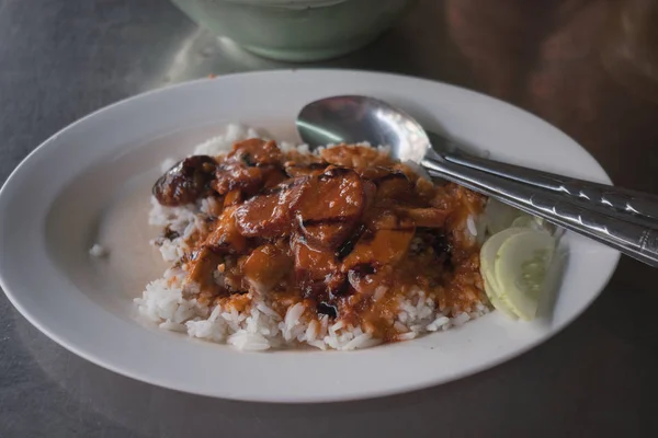 Babi merah berduri dengan saus dengan nasi di atas meja kayu. Makanan Thailand — Stok Foto