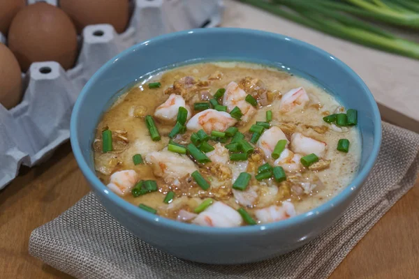 Steamed egg custard cuisine in a blue bowl with minced pork, sau