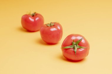 Sarı arka planda kırmızı domatesler