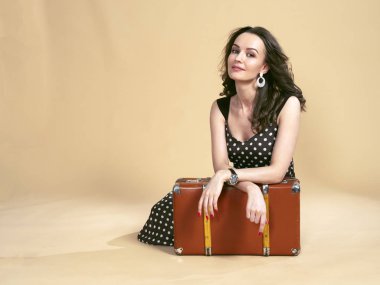 Retro bavul ile polka-nokta elbiseli kız.