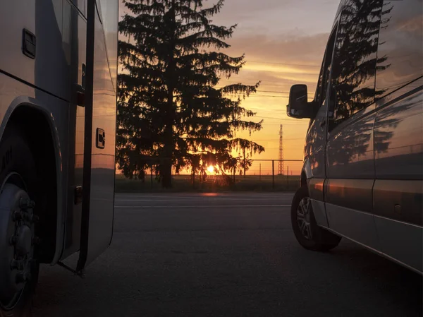 Bus, camper van travels at sunset