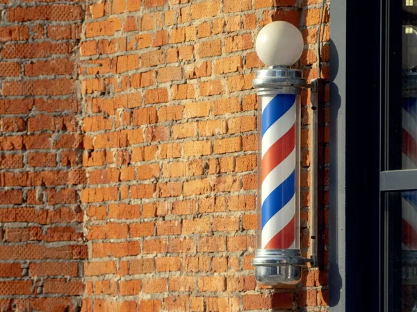 Barbers pole on a brick wall — Stock Photo, Image