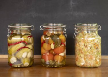 Canned vegetables, pickled tomatoes, pickled cucumbers, sauerkraut clipart