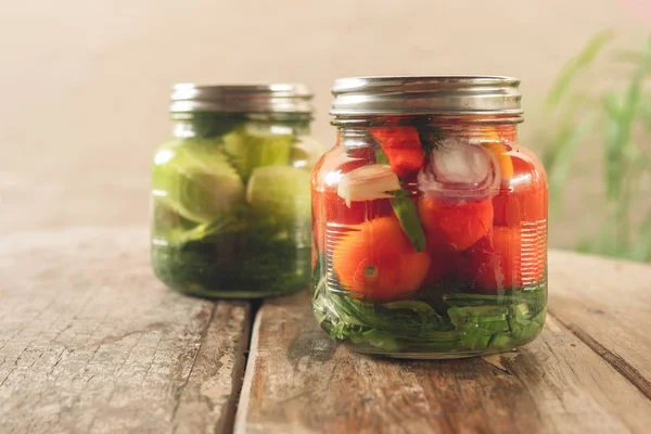 Preservation, pickles, cucumbers and tomatoes in a jar — Stock Photo, Image