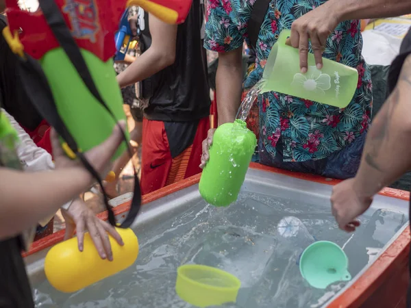 Thailand, Bangkok April 14, 2019 New Year, Songkran, people pour water on each other with water cannons — Stock Photo, Image