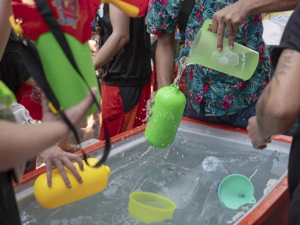 Thailand, Bangkok April 14, 2019 New Year, Songkran, people pour water on each other with water cannons — Stock Photo, Image