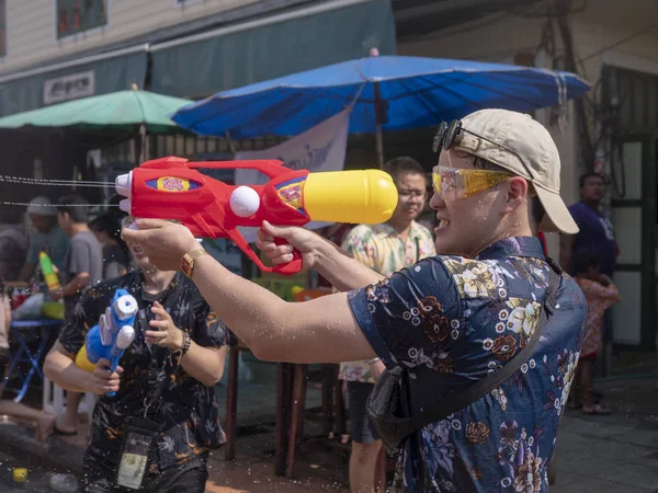 Thailand, Bangkok April 14, 2019 New Year, Songkran, people pour water on each other with water cannons — Stock Photo, Image