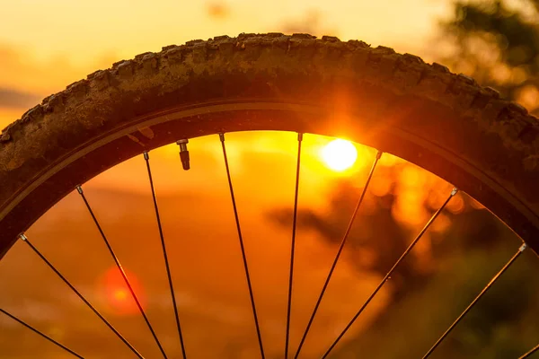 Detail horského kola při západu slunce. Detailní záběr kola pneumatiky. Enduro, sjezd, běh. Mezera pro text. — Stock fotografie