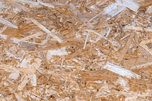 Oriented strand board texture close-up, OSB background, wood construction material.