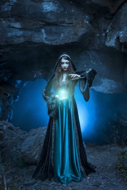 The witch with magic ball in her hands causes a spirits clipart