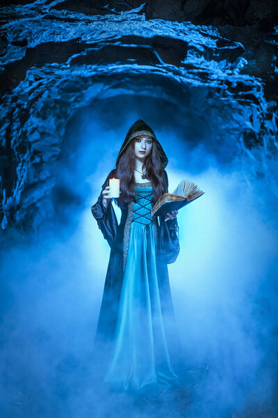 The witch with magic ball in her hands causes a spirits