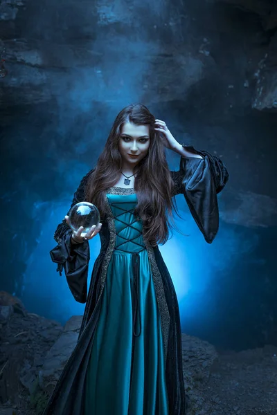 The witch with magic ball in her hands causes a spirits — Stock Photo, Image