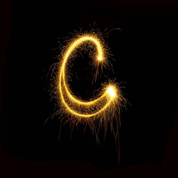 Alphabet sparklers on black background single letter — Stock Photo, Image
