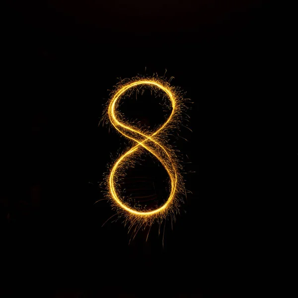 Números 0 a 9 criados usando um sparkler em preto — Fotografia de Stock