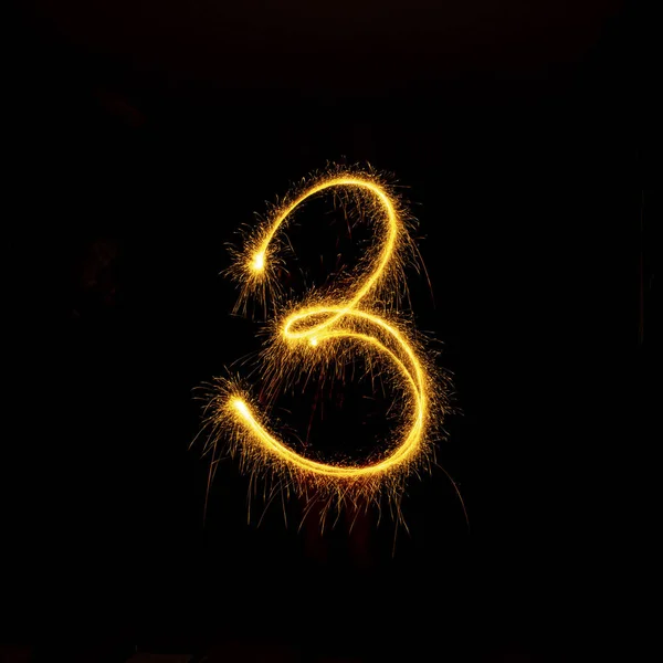 Numbers 0 to 9 created using a sparkler on black