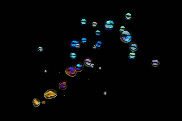 Flying soap bubbles isolated on black background. — Stock Photo, Image