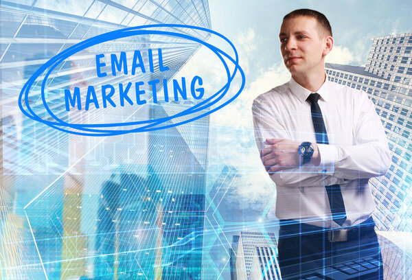 The concept of business, technology, the Internet and the network. Young businessman showing inscription: Email marketing