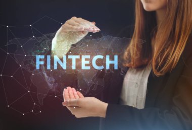 İş, teknoloji, Internet ve ağ kavramı. Geleceğin sanal bir ekranda çalışan genç bir girişimci ve yazıt görür: Fintech