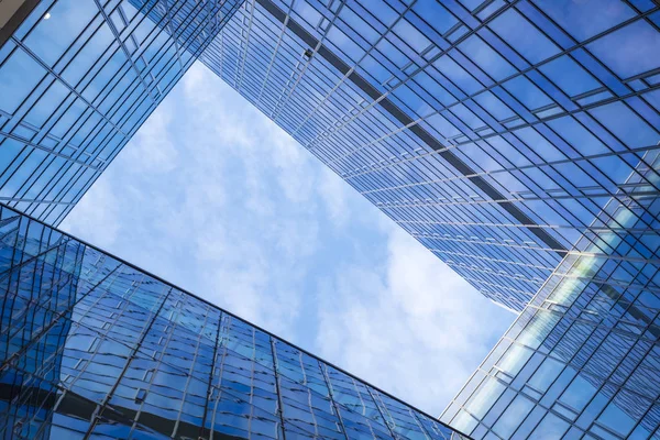 bir sürü cam kullanıldığı modern mimarisi ile modern bina ve temiz çizgiler ve burada gökyüzü pencerelerde yansıtır.