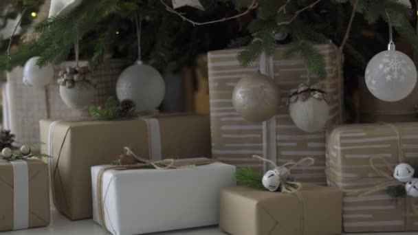 Christmas tree with decorations and presents under it in loft interior. — Stock Video