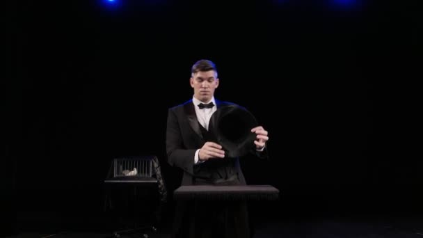 A man dressed as a magician pulling a rabbit from his hat — Stock Video