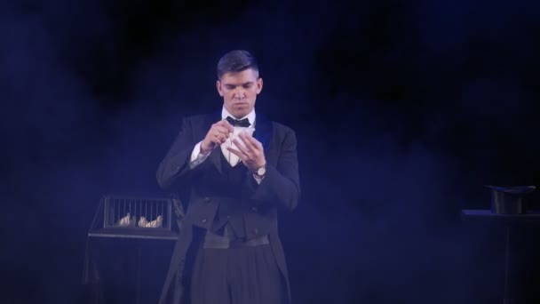 Magician showing a magic trick with fire and shawl — Stock Video
