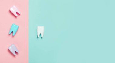 Toothbrush and big tooth on blue and pink background. Teeth care minimalism concept. clipart