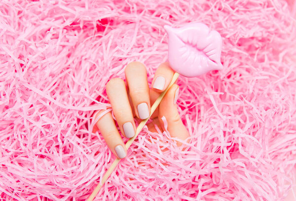 Beautiful woman manicure on creative pink background. Minimalist trend.