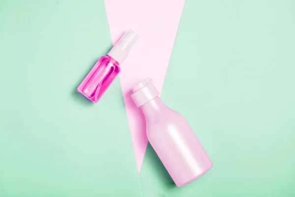 Creative minimal beauty and health background with pink bottle