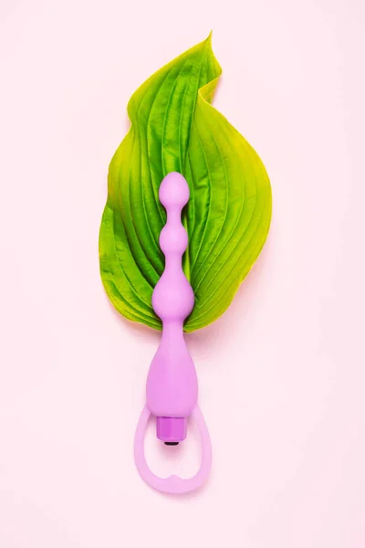 Adult sexy toy in green pure leaf. — Stock Photo, Image