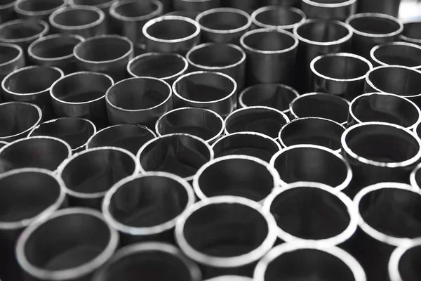 Round edges of metal pipes in the form of a background. Sections of pipes of different lengths.