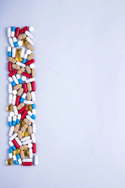 Pharmaceutical preparations, background. Colorful medications Pills, tablets and capsules are scattered. Medical concept.
