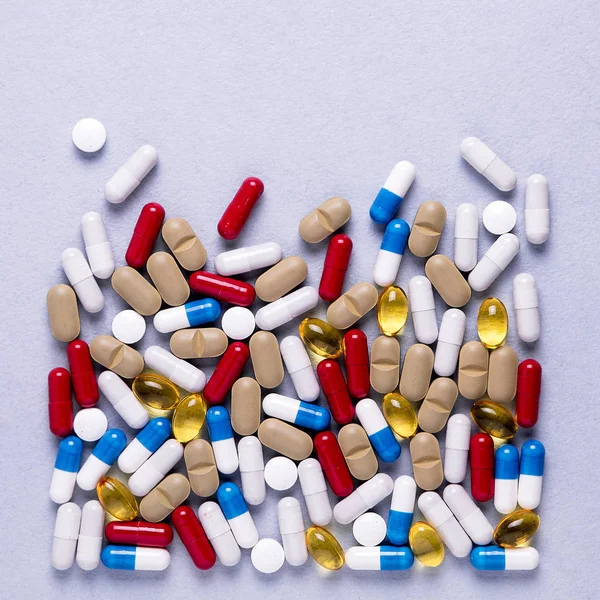 Pharmaceutical preparations, background. Colorful medications Pills, tablets and capsules are scattered. Medical concept.