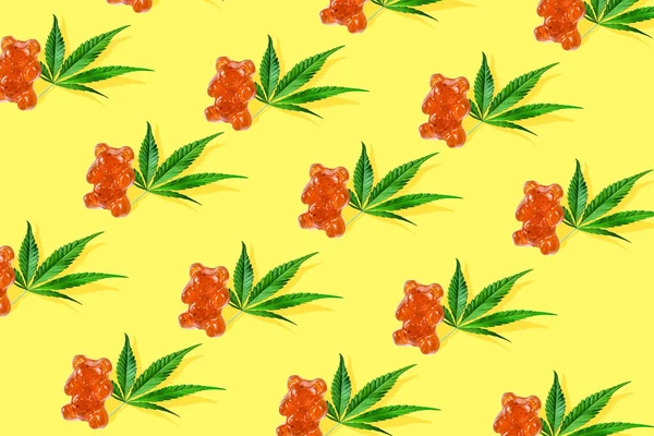 Sarı bir arka plan üzerinde Cbd yağı ile bir ayı şeklinde Desen gummies. Minimum Cbd konsepti