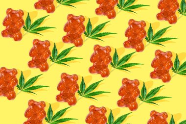 Sarı bir arka plan üzerinde Cbd yağı ile bir ayı şeklinde Desen gummies. Minimum Cbd konsepti