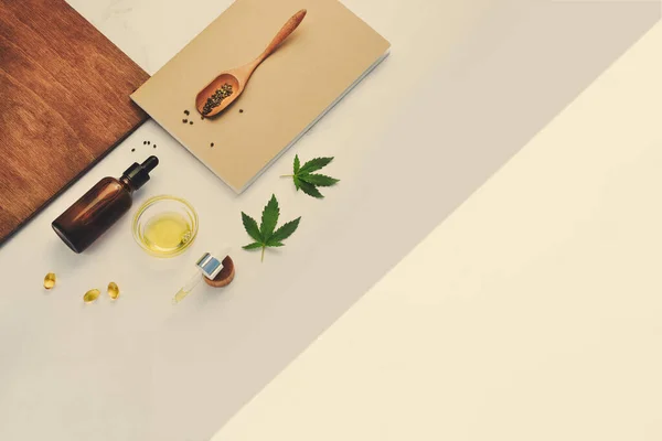 CBD oil, hemp tincture with pipette on beige background with cannabis leaves — Stock Photo, Image